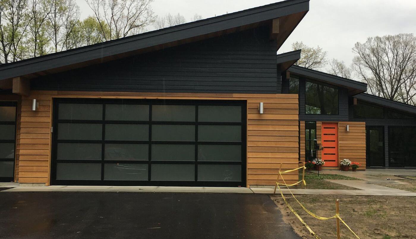 A contemporary home featuring a sleek garage door, showcasing modern architectural design.