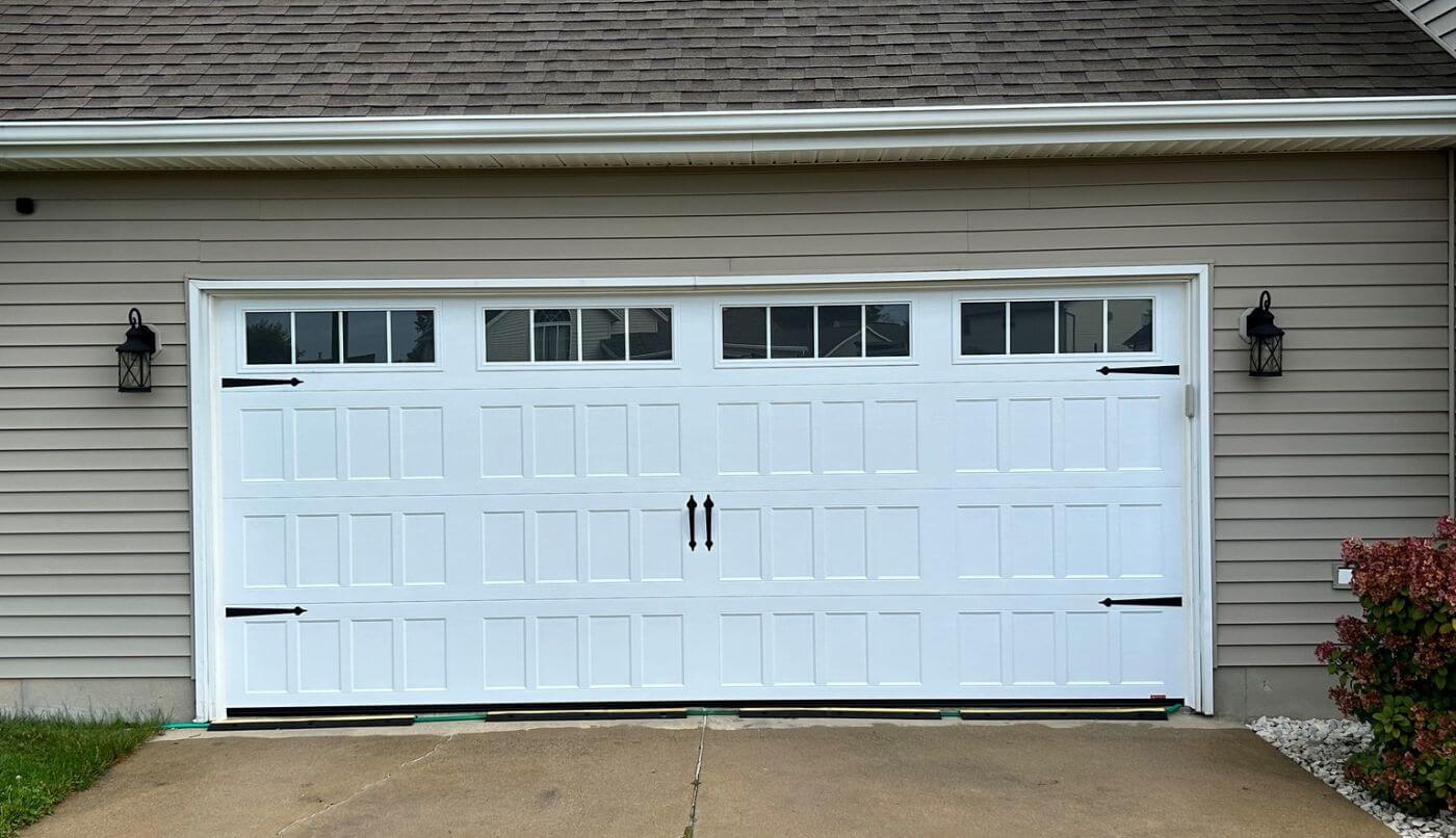 A garage door with windows, highlighting simplicity and elegance in its appearance.