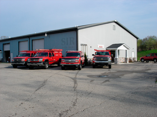 Four Environmental trucks in front of their office